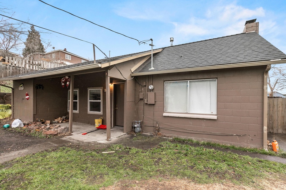 A house with a red door and a white car parked in front with the text "Call Jordan 479-857-7207".