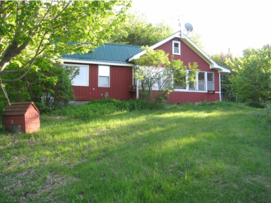 A house with a red door and a white car parked in front with the text "Call Jordan 479-857-7207".