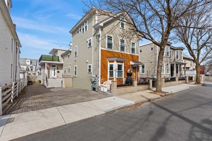 A house with a red door and a white car parked in front with the text "Call Jordan 479-857-7207".