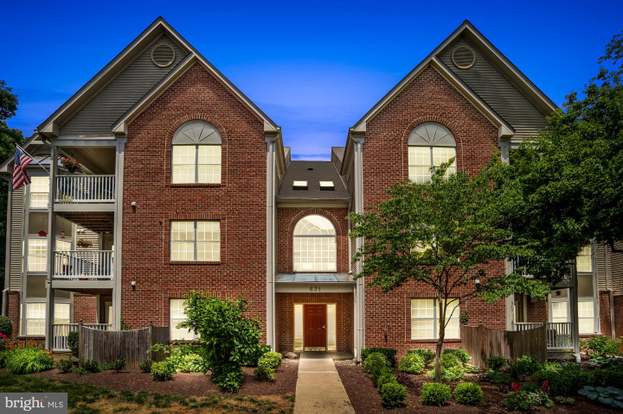 A house with a red door and a white car parked in front with the text "Call Jordan 479-857-7207".